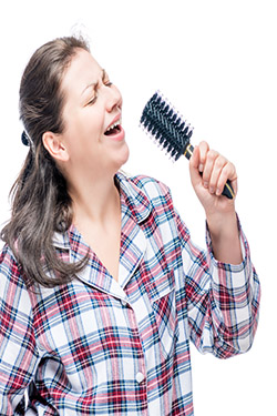 woman singing into hairbrush